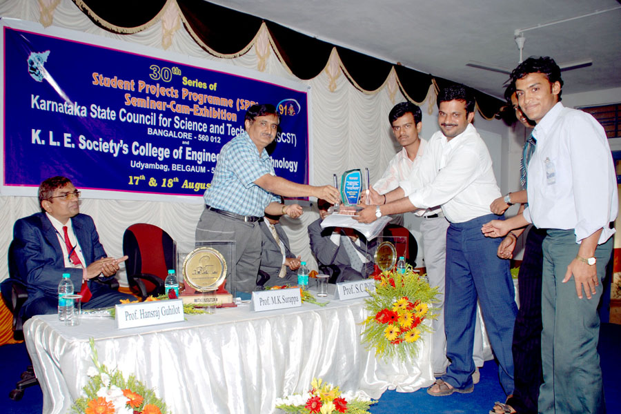 SAE/BAJA race car team with trophy